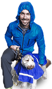 Rob Medsger, owner & trainer at 3Strong Fitness with his dog in a blue poncho